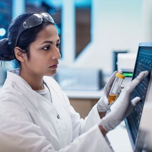 A Pharmacy Tech pushes the screen on a touchscreen computer