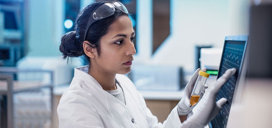 Scientist studying information on a computer