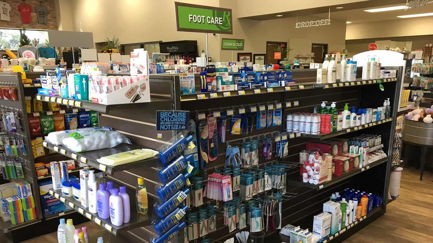 Interior of a pharmacy showing aisles and shelves full of medications