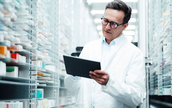 Pharmacist checking inventory in the stock room.