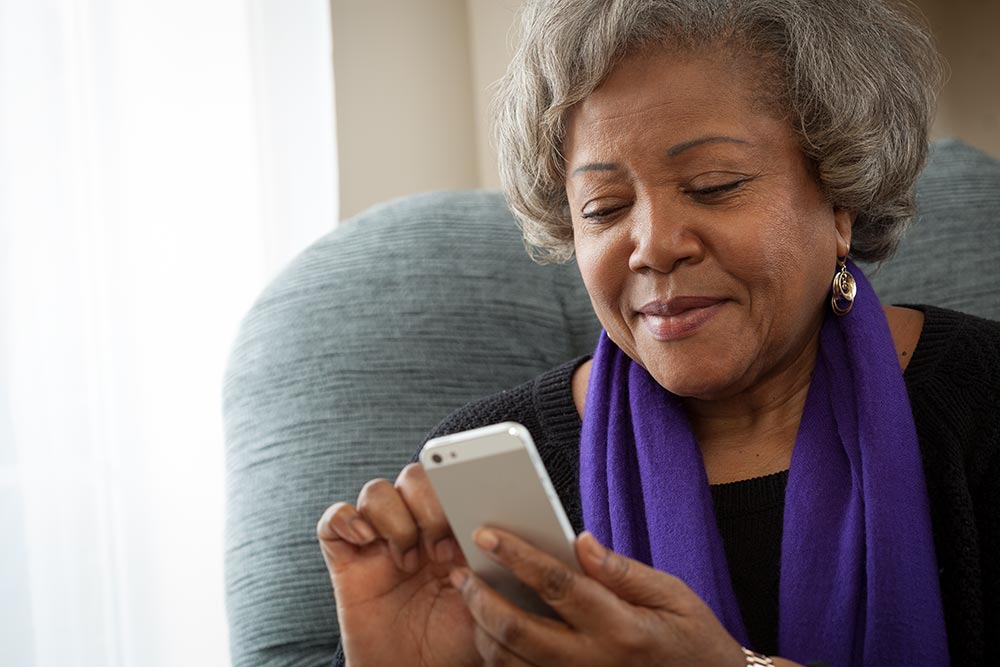 A woman sitting in a chair using a cellphone