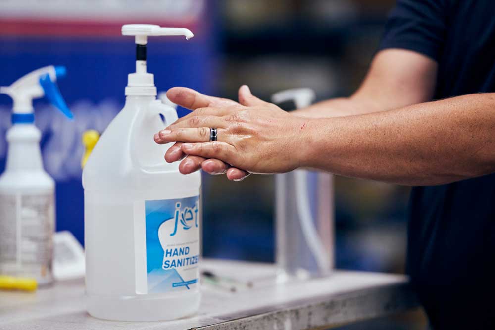 A person scrubbing their hands with hand sanitizer